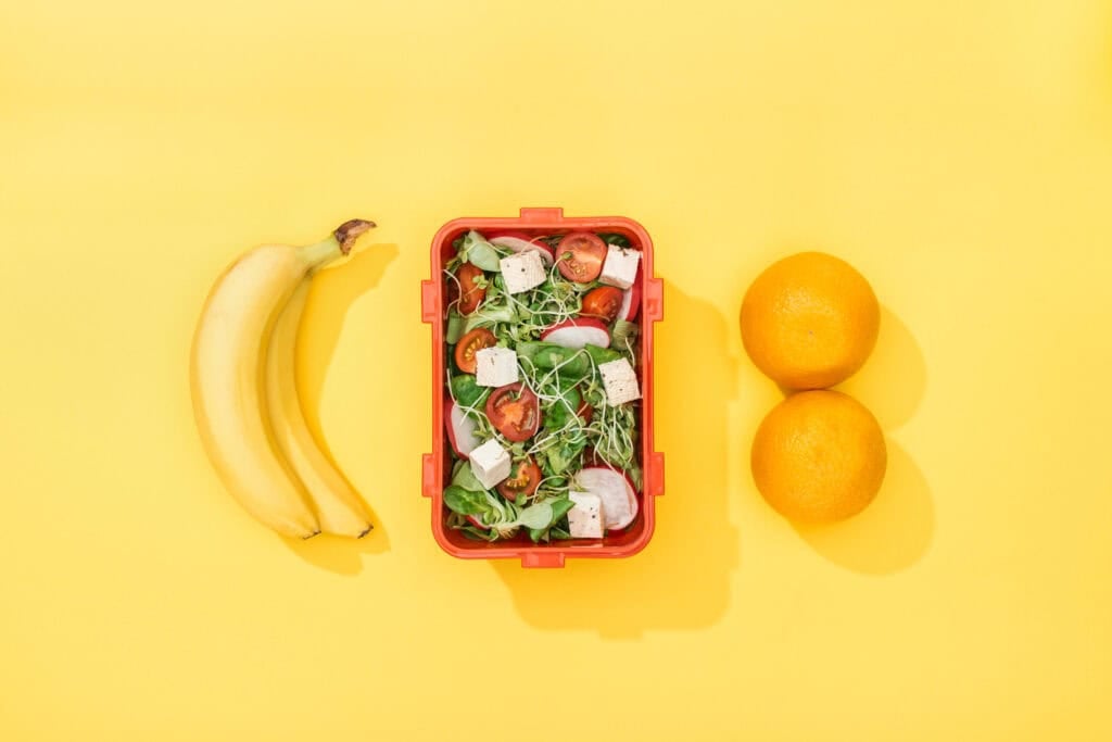 bananas, oranges, and a salad for the article how to get free food image